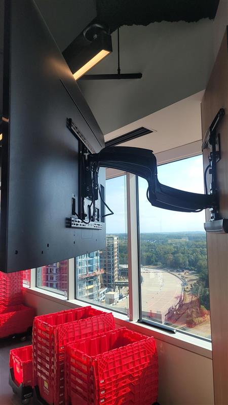 TV mount arm installation in high-rise commercial space